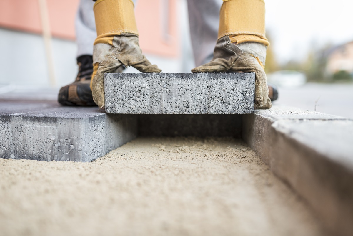 Builder laying a paving block