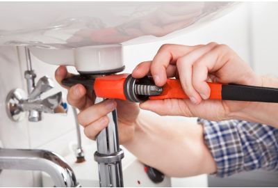 Plumber fixing a pipe on a sink