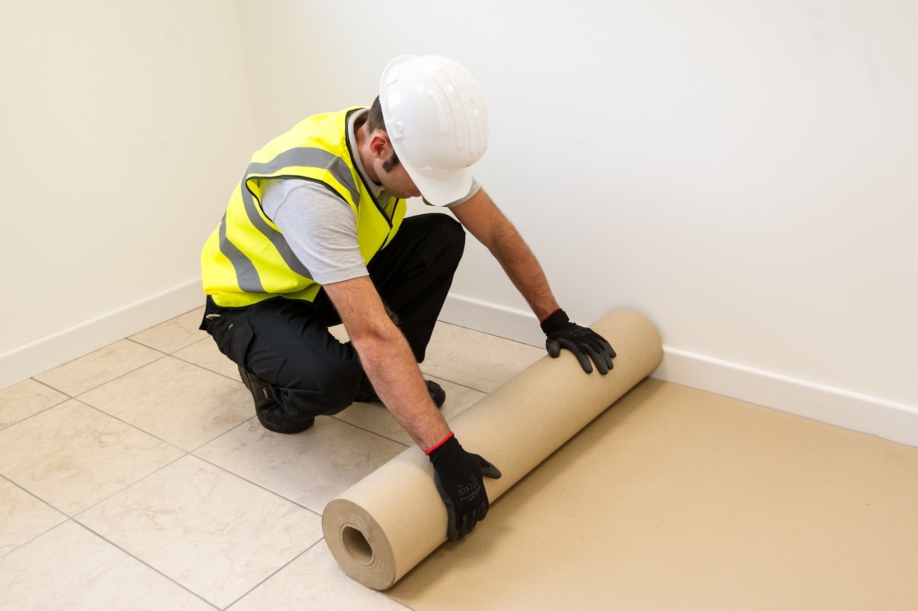 Man laying protective flooring