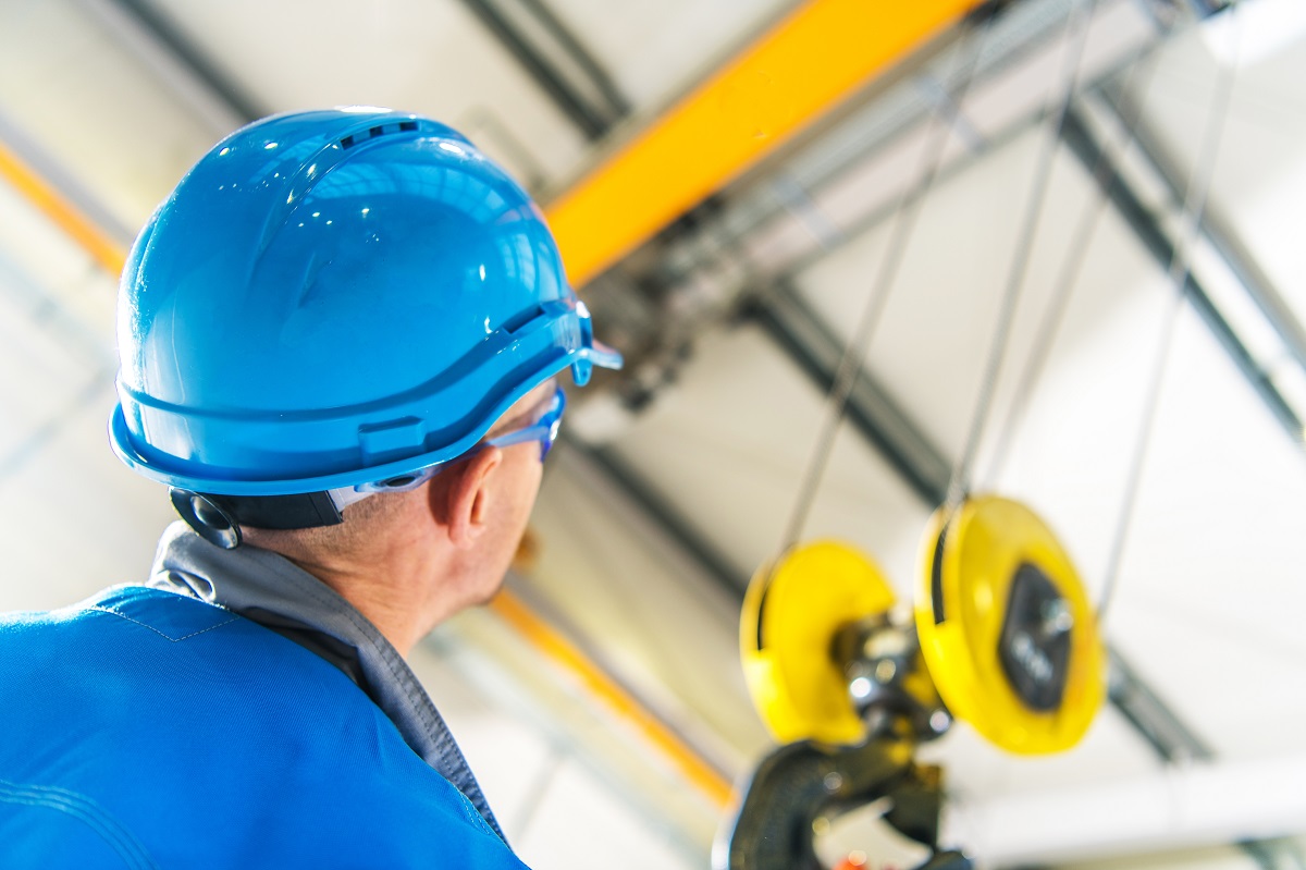 A construction worker wearing a blue hard hat
