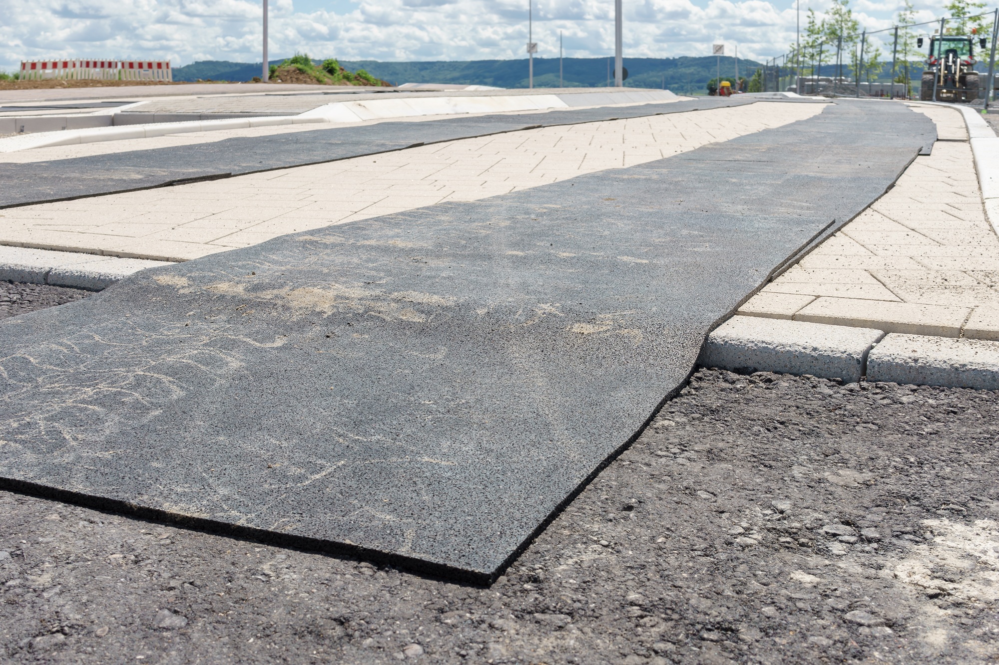Ground mats protecting a newly laid road