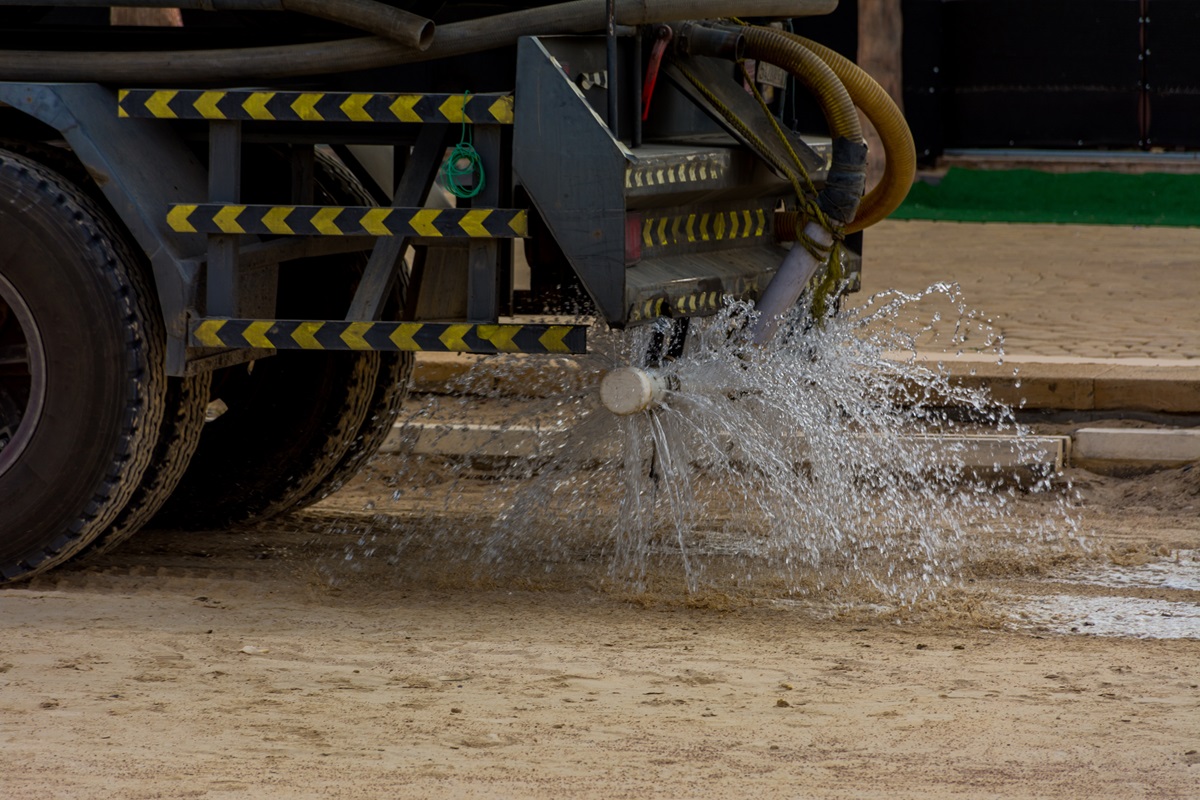 A truck sprays water on a construction site