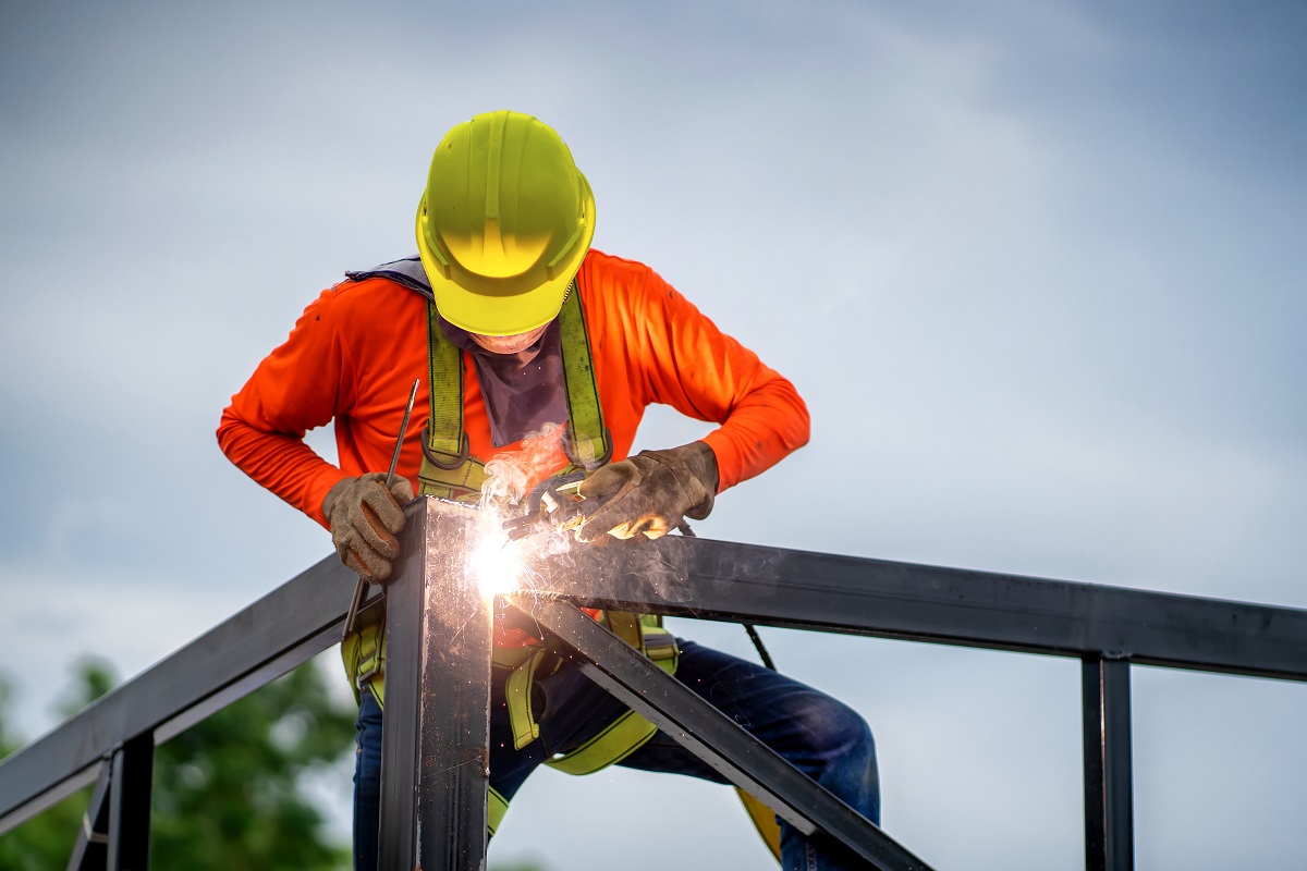 Construction worker welding steel frames
